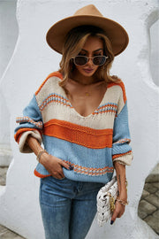 Deep plunge stripe knit pullover sweater with blue, orange, and cream stripes.