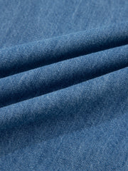 Blue denim fabric with visible texture and folds.