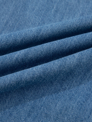 Blue denim fabric with visible texture and folds.