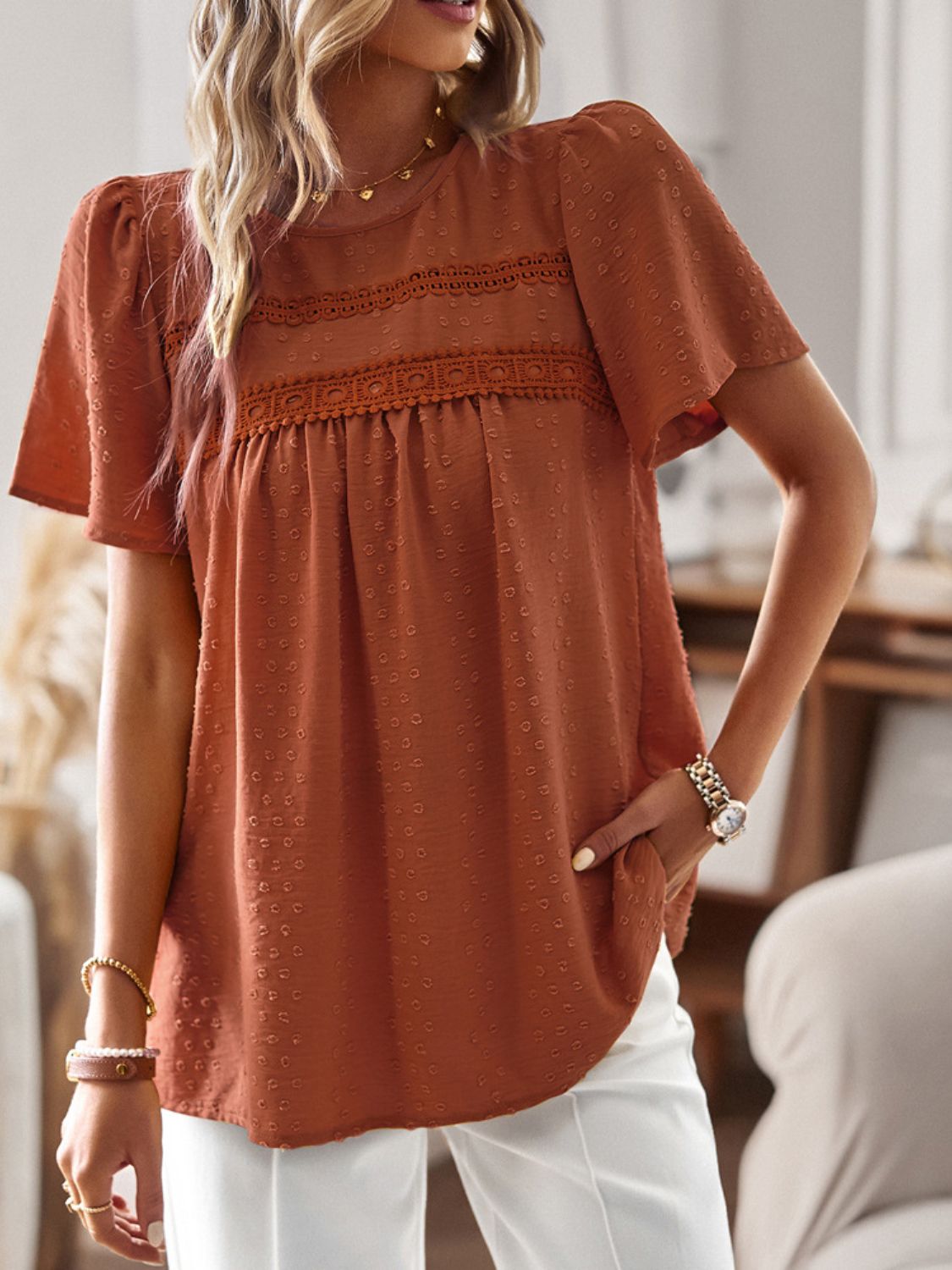 Textured puff sleeve yoke top in terracotta with lace detail and short sleeves.