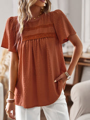 Textured puff sleeve yoke top in terracotta with lace detail and short sleeves.