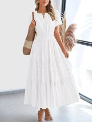 White ruched V-neck tiered midi dress with short sleeves and smocked waist.