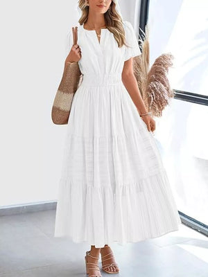 White ruched V-neck tiered midi dress with short sleeves and smocked waist.
