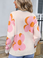 Ivory knit sweater with oversized pink and orange floral print, crew neck, long sleeves.