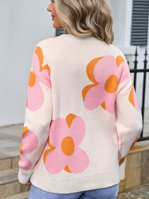 Ivory knit sweater with oversized pink and orange floral print, crew neck, long sleeves.