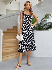 Graphic print tiered midi dress with ruffle straps and square neckline in black and white.