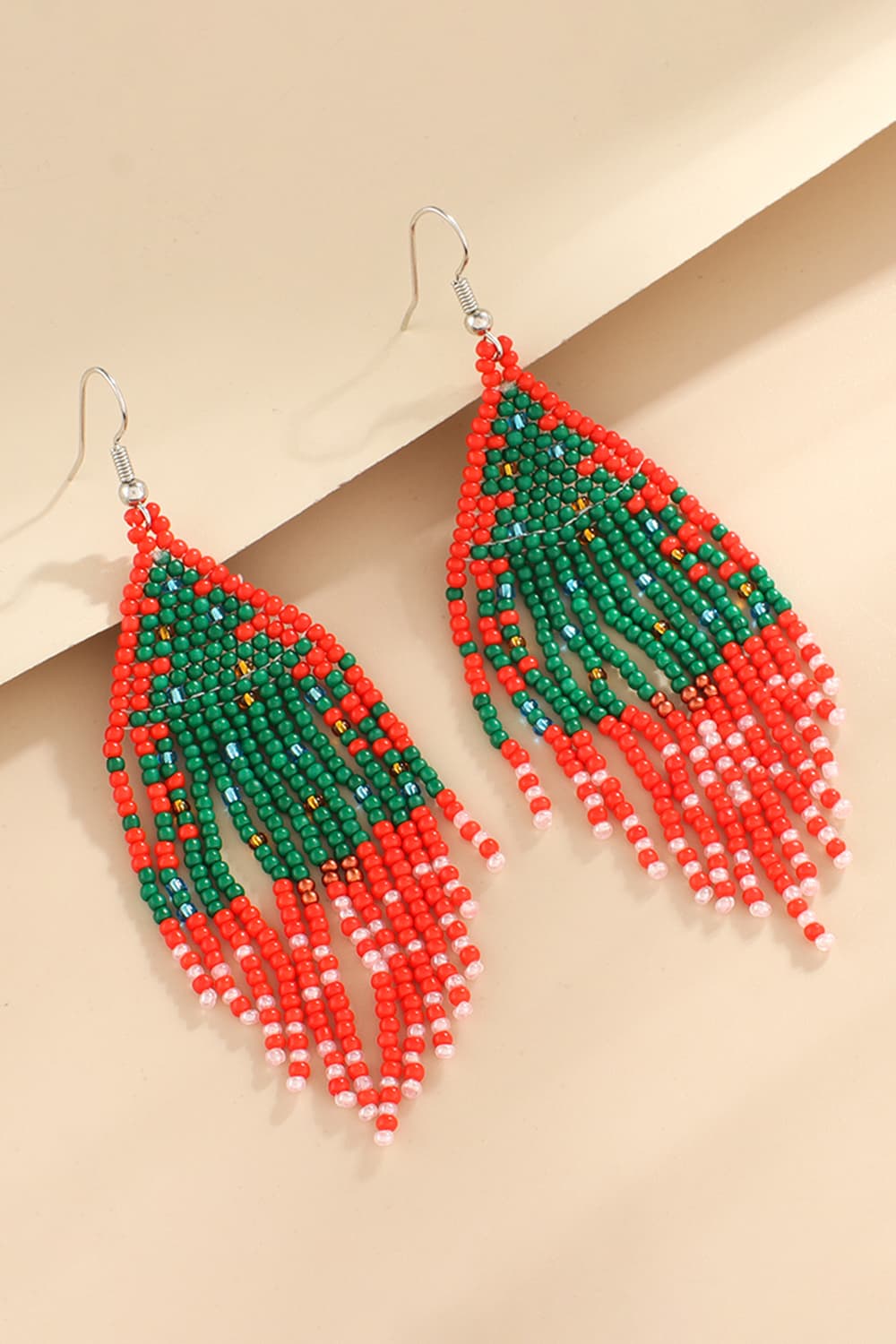 Beaded Christmas tree drop earrings in green, red, and white.