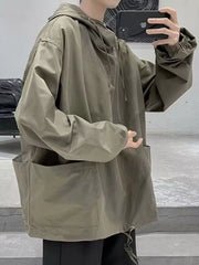 Oversized green drawstring hoodie with large front pockets and cinched cuffs.