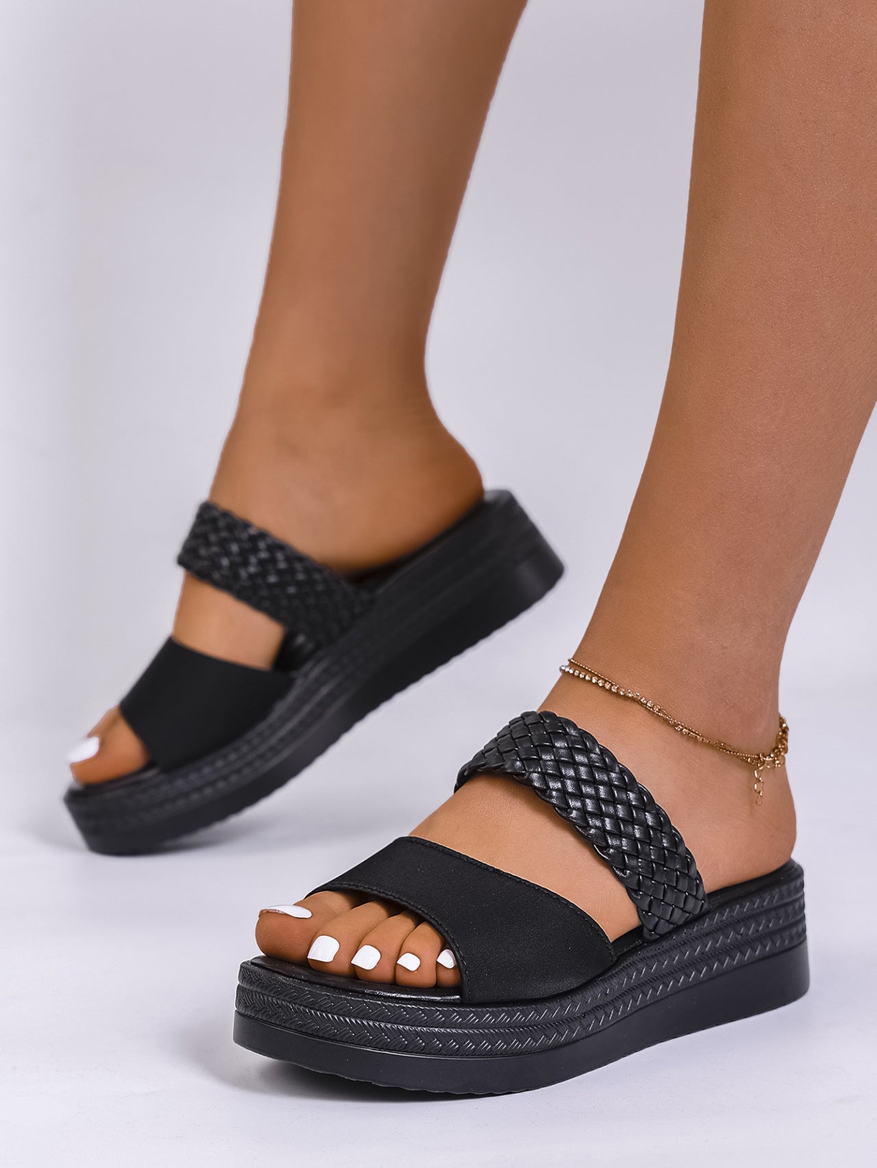 Chic black two-strap platform sandals with braided detail and chunky sole.
