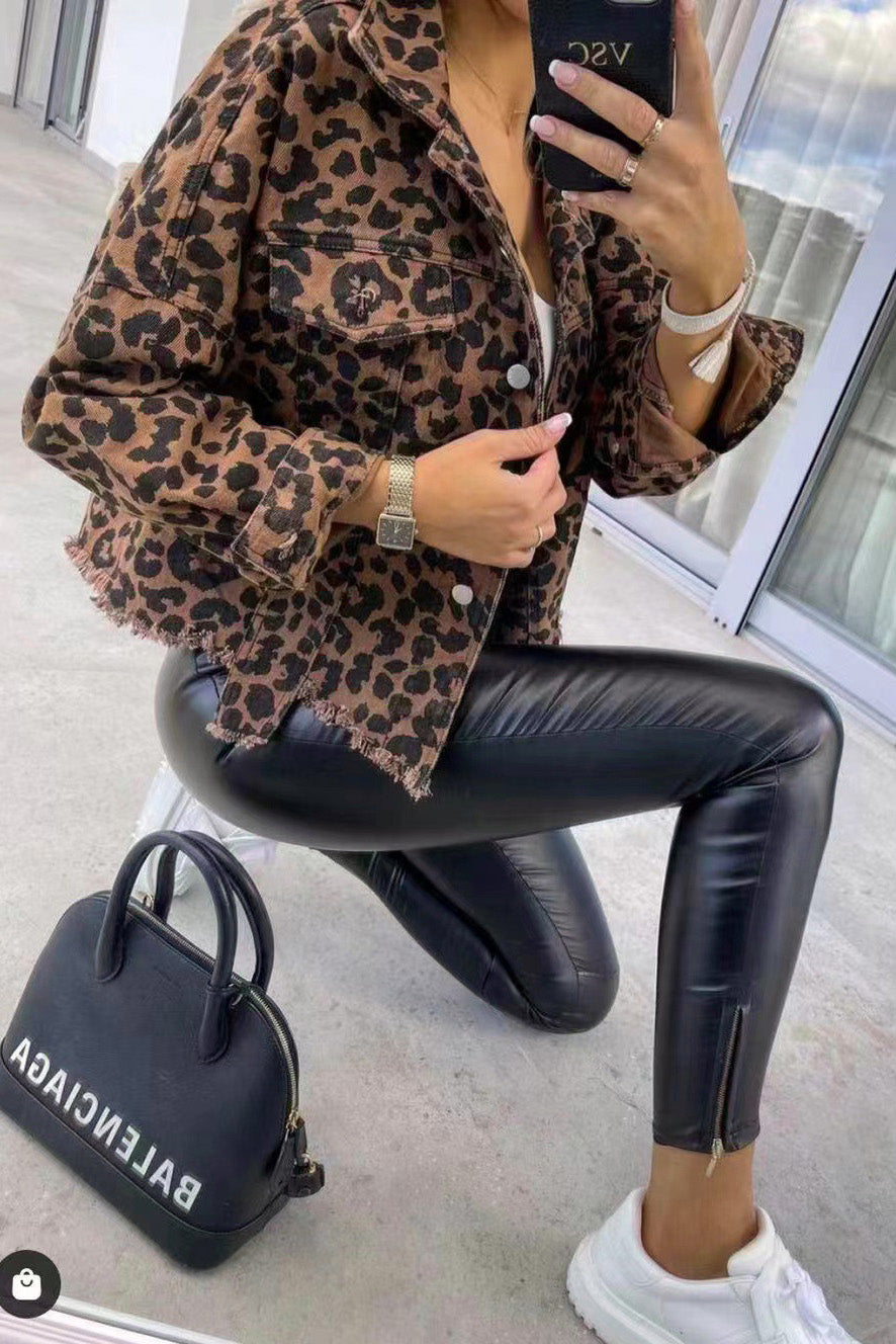 Leopard print denim jacket with frayed hem and buttoned pockets.