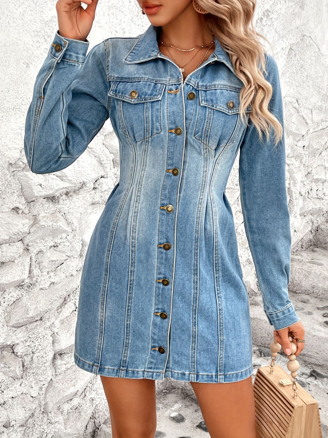 Medium wash denim button-down mini dress with long sleeves and a sculpted fit.