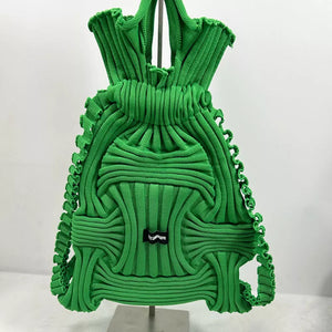 Textured knit medium backpack bag in light green with intricate woven detail and ruffled edges.