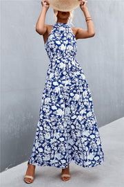 Blue floral print maxi dress with halter neckline and tiered skirt.