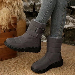 Gray quilted round toe platform boots with adjustable strap and chunky sole.