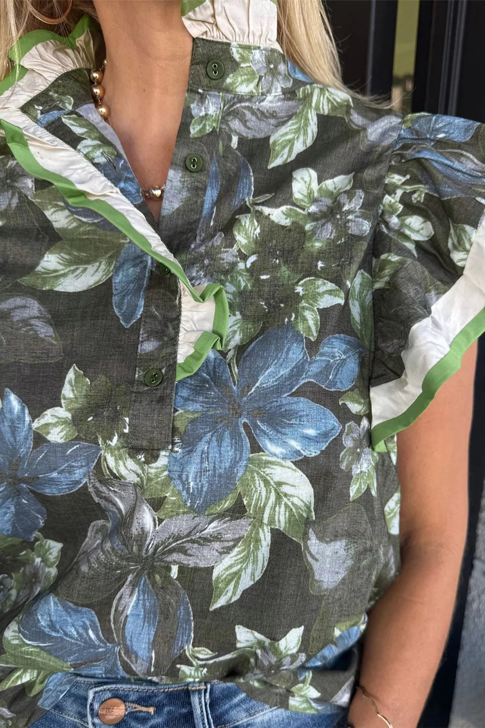 Botanical print cotton shirt with ruffle sleeves and collar, featuring green trim.