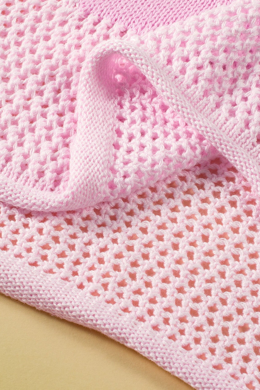 Blush pink openwork knit sweater with floral intarsia detail, acrylic.