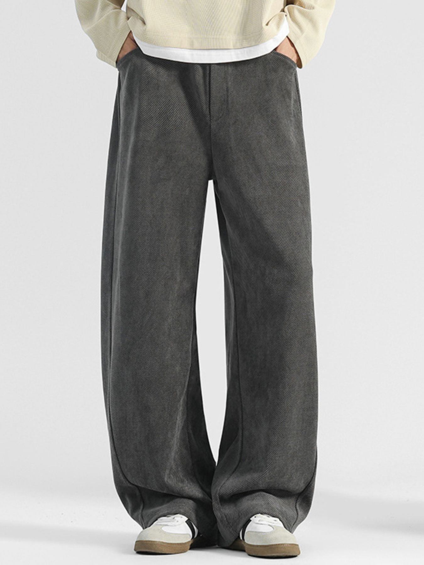 Men's dark gray loose fit sweatpants with pockets and a subtle herringbone texture.