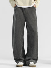 Men's dark gray loose fit sweatpants with pockets and a subtle herringbone texture.