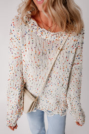 White confetti knit sweater with distressed hem and colorful flecks.