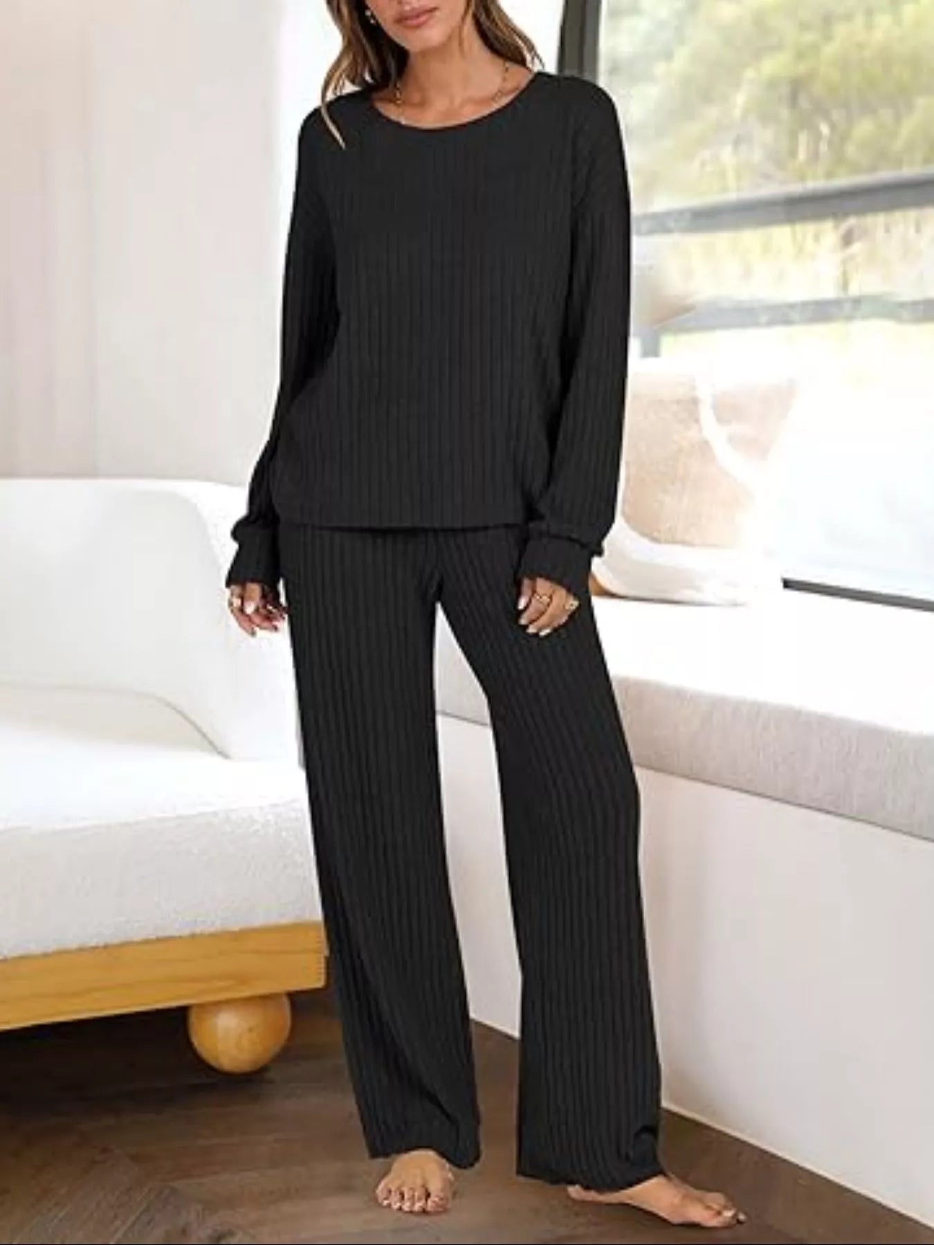 Black ribbed knit lounge set with crew neck top and wide leg pants.