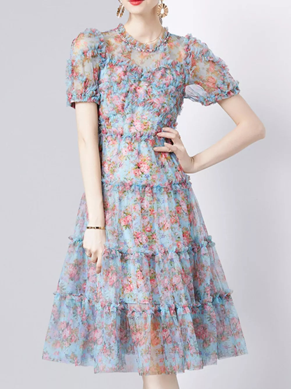 Light blue floral print dress with ruffles and short sleeves.