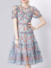 Light blue floral print dress with ruffles and short sleeves.