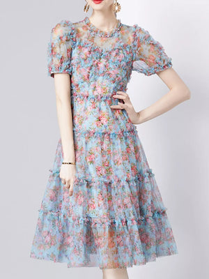 Light blue floral print dress with ruffles and short sleeves.