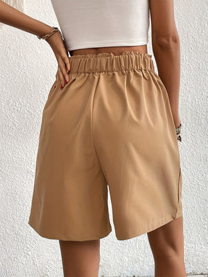 Khaki pleated front bermuda shorts with elastic waist and side pockets.