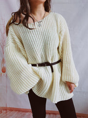 Oversized cream ribbed knit sweater with belted waist and balloon sleeves.