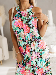 Maxi dress with floral print, braided straps, and belted waist.