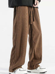 Brown corduroy wide-leg sweatpants with drawstring waist and vertical ribbing.