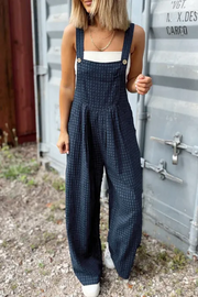 Dark blue textured wide-leg overalls with button detail and pockets