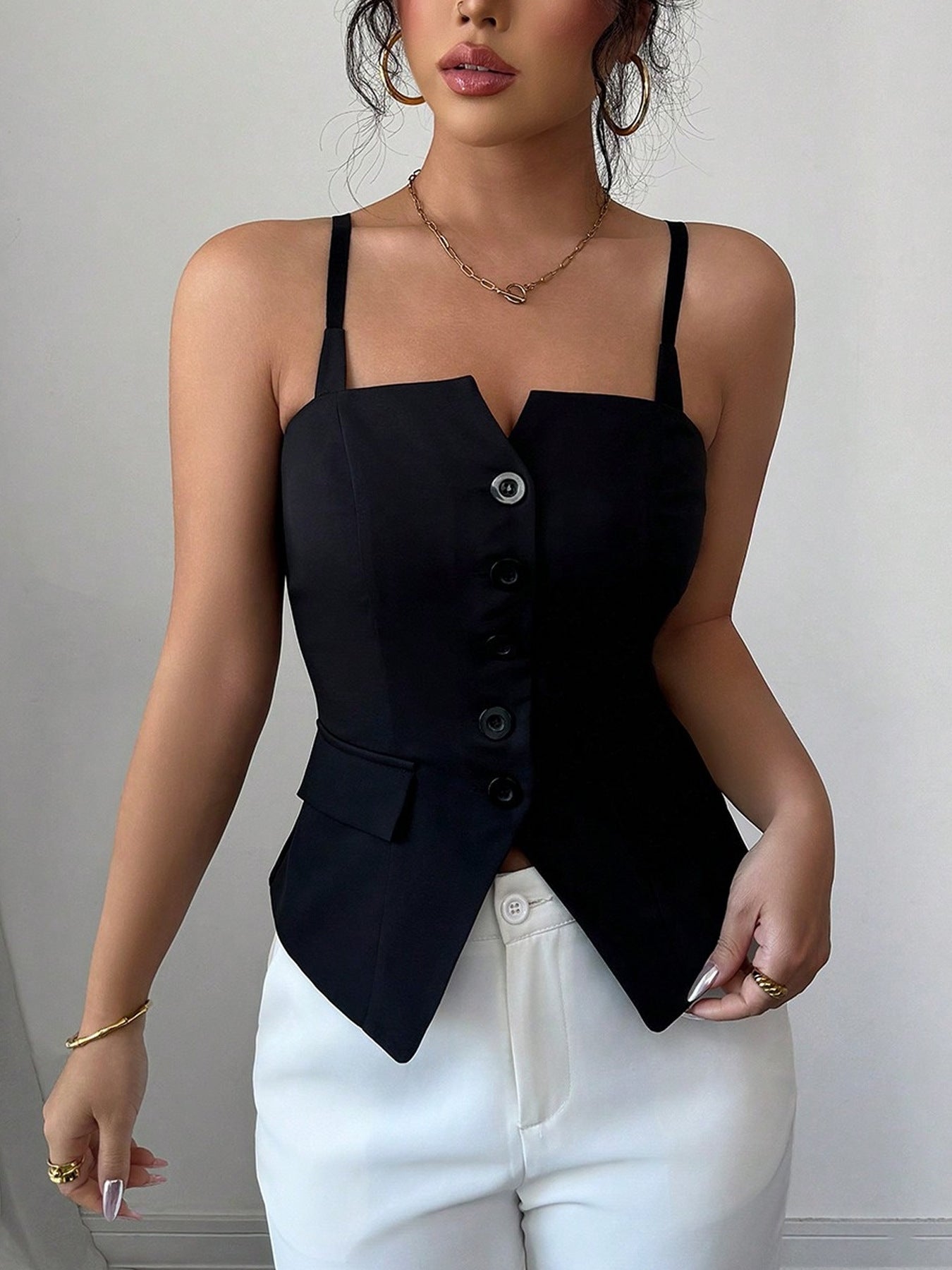 Black V-cut button-front cami top with adjustable straps and a pocket detail.