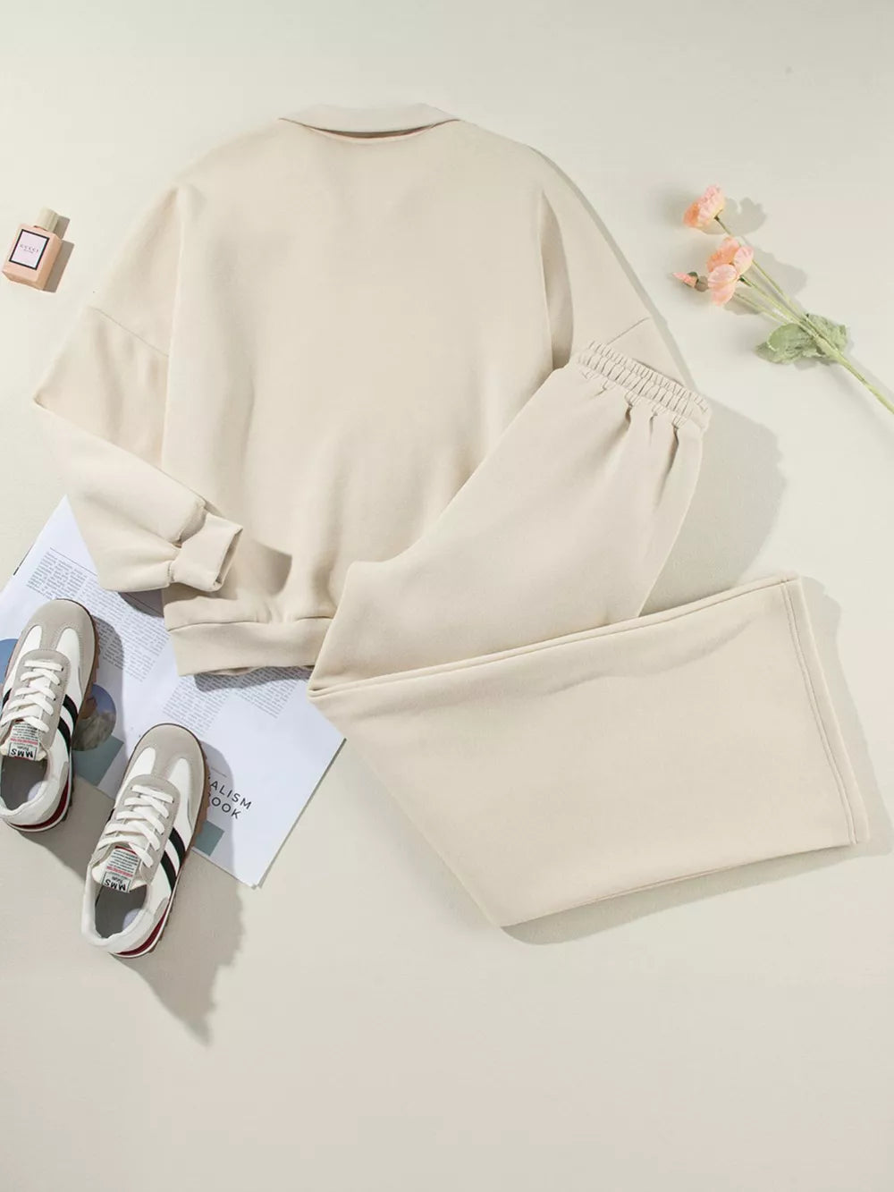 Beige cotton zip-up jacket and drawstring pants set with cuffed sleeves and elastic waistband.