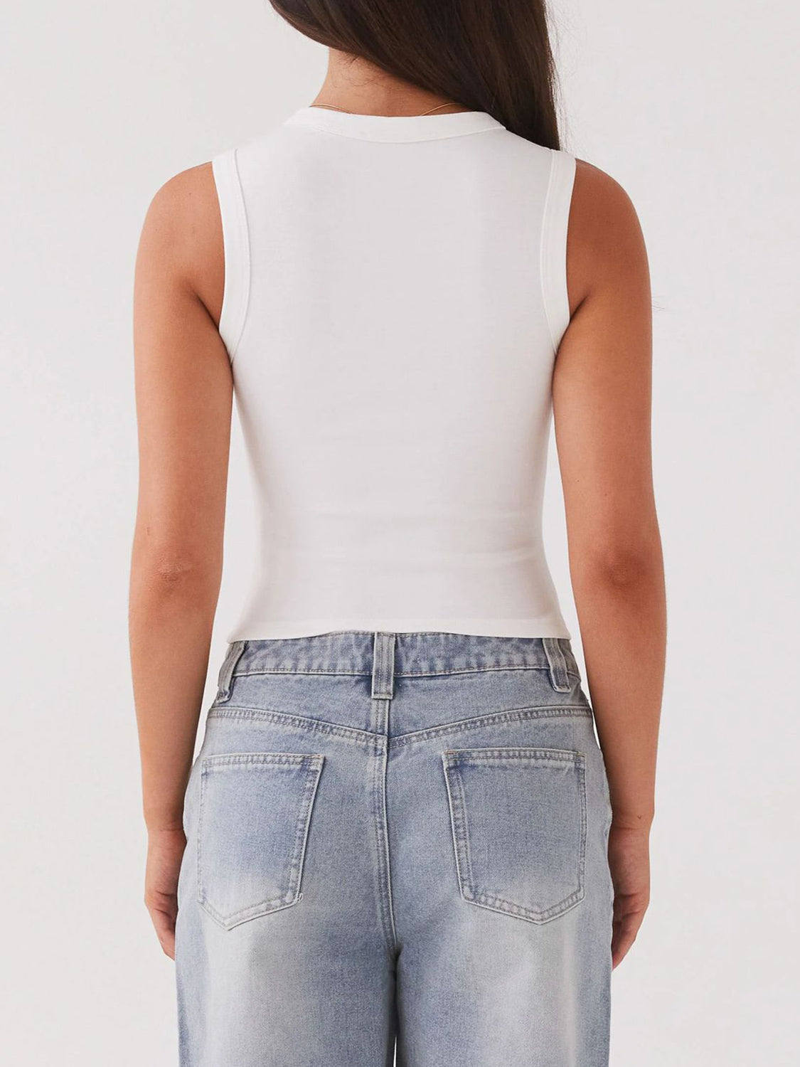 White ribbed knit button-down crop top with a high neckline.
