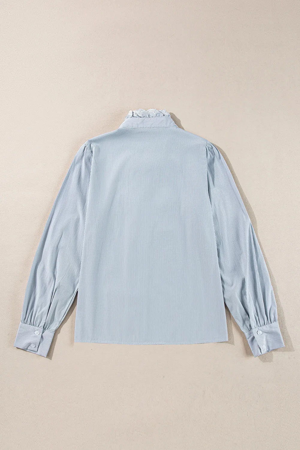 Light blue pinstripe blouse with ruffled collar and puff sleeves.