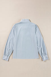 Light blue pinstripe blouse with ruffled collar and puff sleeves.