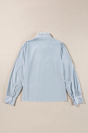 Light blue pinstripe blouse with ruffled collar and puff sleeves.