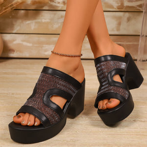 Black open-toe block heel sandals with cut-out details and a glitter fabric insert.