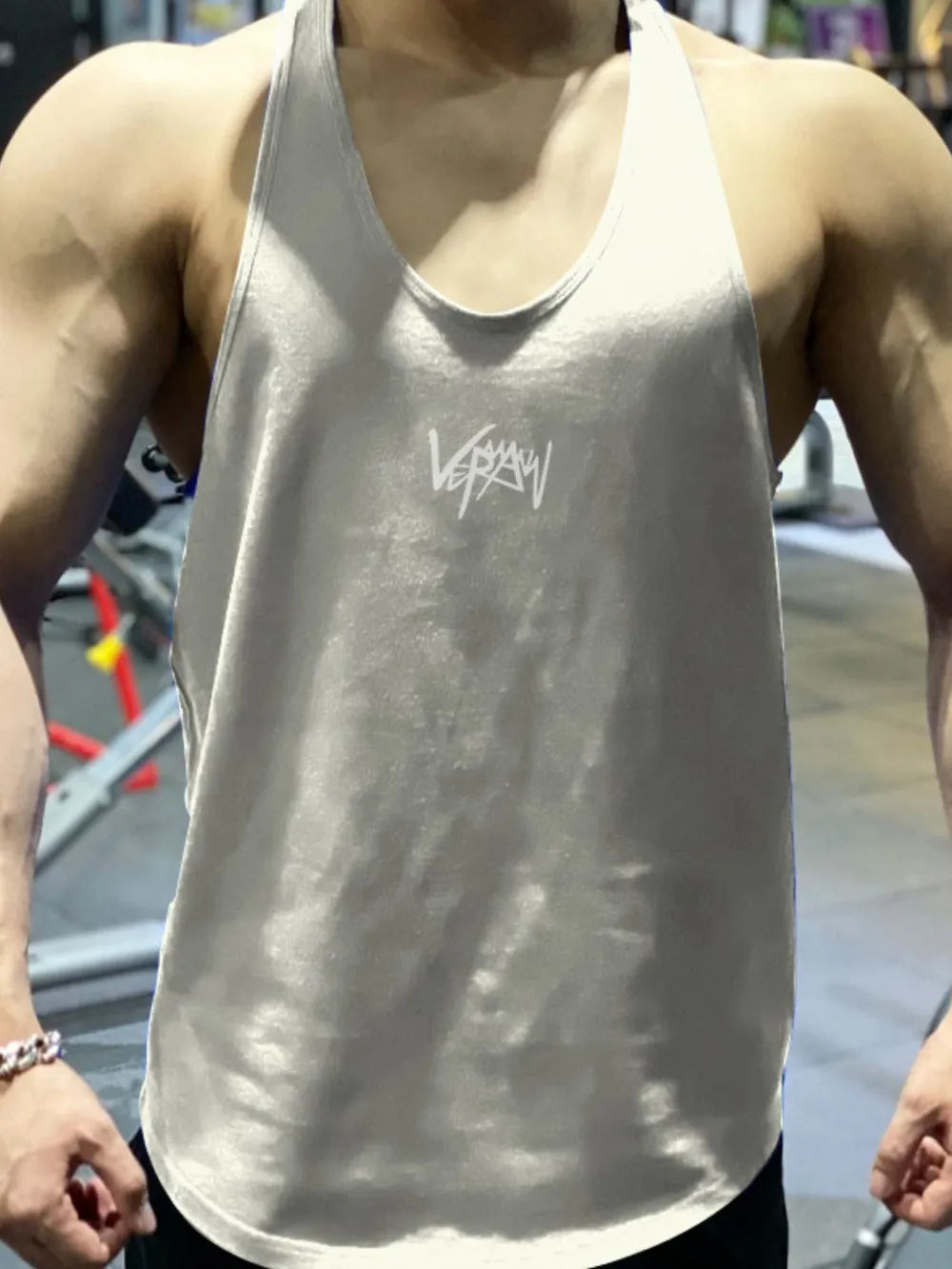 Gray performance racerback tank top with graphic detail on chest