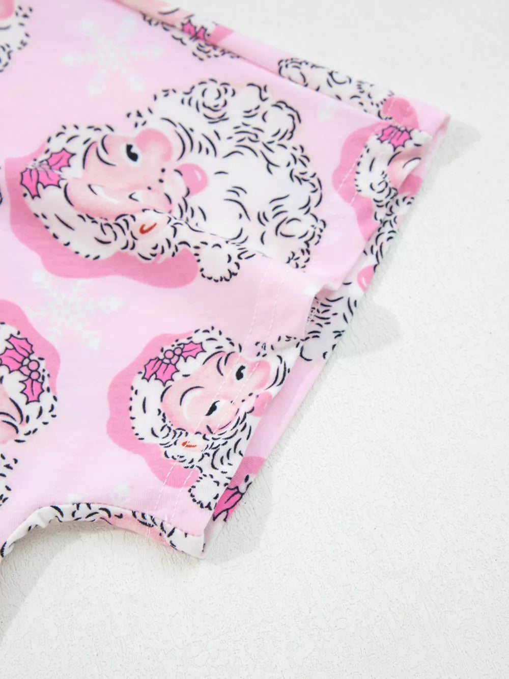 Pink Santa print pajama set with V-neck and short sleeves.
