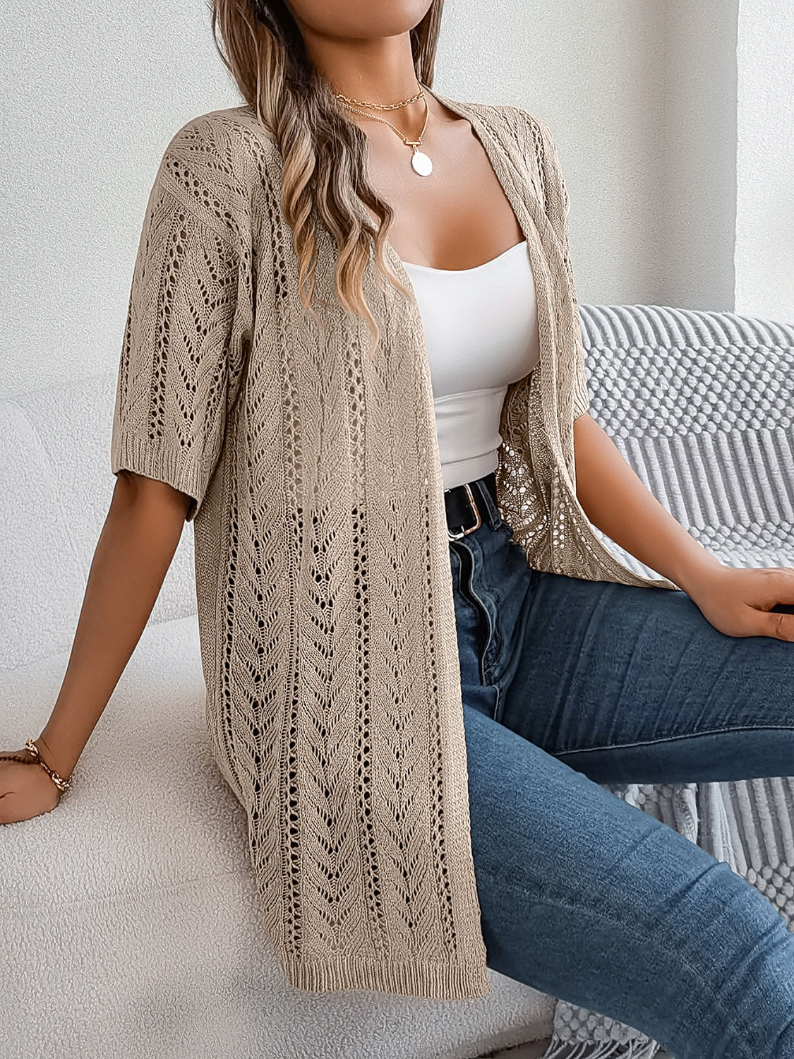 Open-knit chevron sleeve cardigan in tan acrylic with short sleeves and an open front.