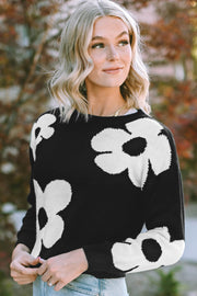 Black acrylic crewneck sweater with large white floral intarsia pattern.