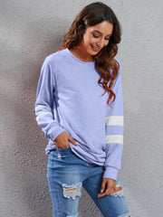 Varsity stripe raglan sweatshirt dress in blue purple with white stripes on sleeves.