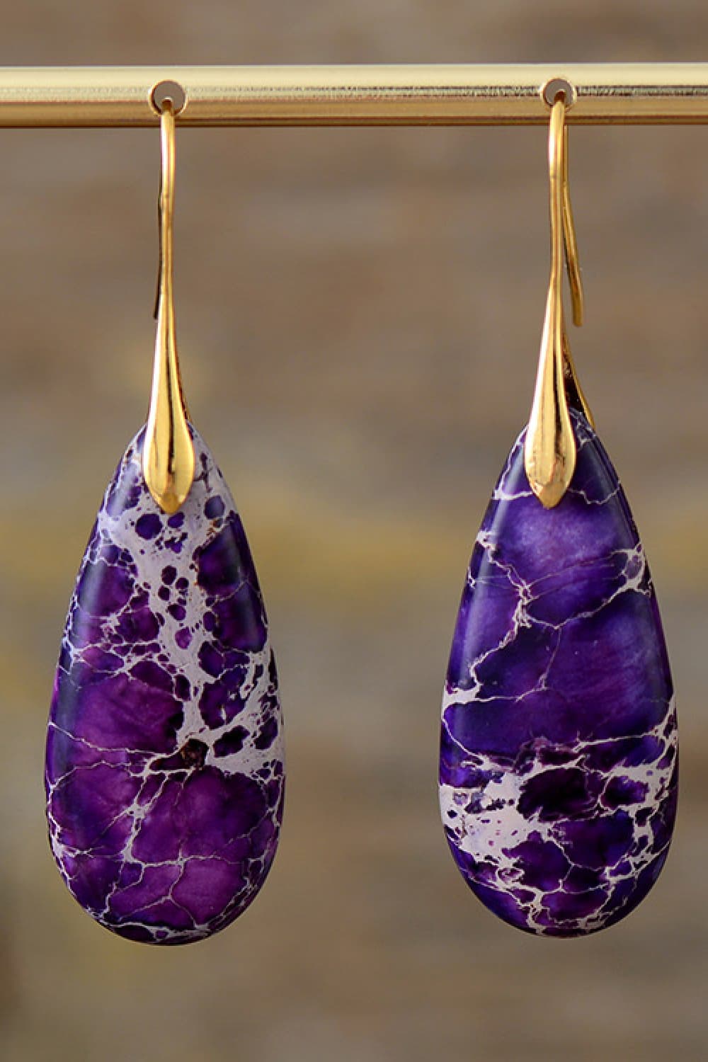 Purple and gold dangle earrings with teardrop-shaped ocean jasper stones.