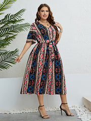 Geometric print midi dress with tie waist, V-neck, short sleeves, and A-line skirt in multicolor.