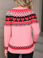 Pink acrylic sweater with festive heart motif, crew neck, and patterned hem.