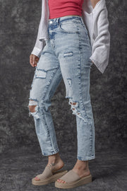 Distressed wash light denim slim leg jeans with ripped details