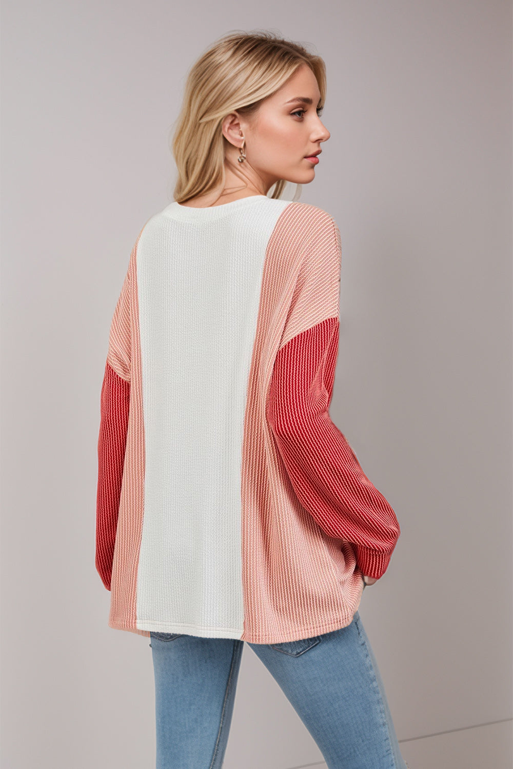 Colorblock waffle knit pullover sweater in white, pink, and red with long sleeves.