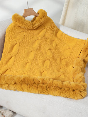 Gold cable knit poncho with faux fur trim and collar detail.